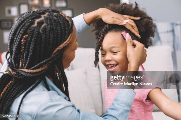 mother styling daughter's curly hair - afro hairstyle stock pictures, royalty-free photos & images