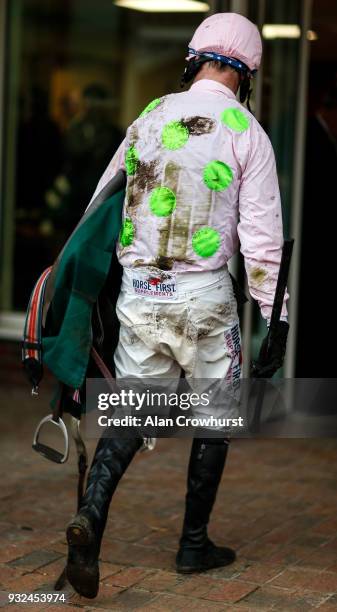 Muddied Robbie Power returns to the weighing room at Cheltenham racecourse on St Patrick's Thursday on March 15, 2018 in Cheltenham, England.