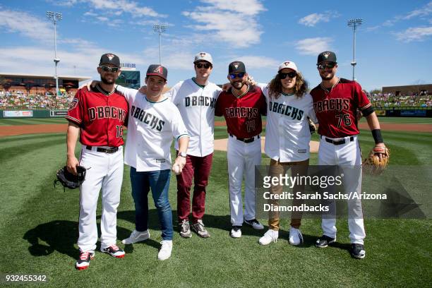 Actors Adam Devine, Anders Holm and Blake Anderson pose with Chris Owings, Reymond Fuentes and Jack Reinheimer of the Arizona Diamondbacks after...