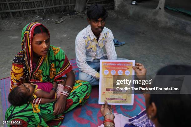 An Accredited Social Health Activist discusses family planning options with a young couple. ASHAs are trained and supported by Pathfinder...