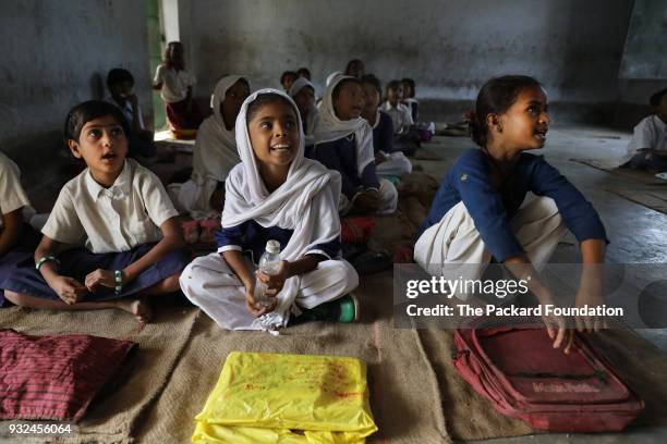 Young students at Middle School Keoti Balak enjoy a poem sung by their classmate. Teachers at the school deliver CorStone's Youth First program, an...