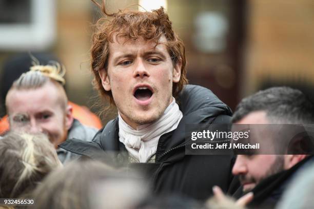 Sam Heughan from the TV series Outlander departs a filming location at St Andrew's Square on March 15, 2018 in Glasgow, Scotland. Dozens of fans have...