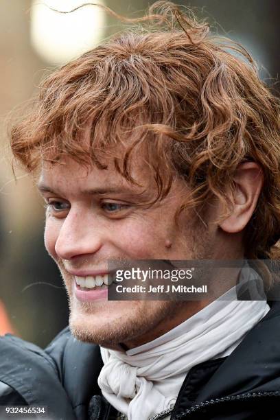 Sam Heughan from the TV series Outlander departs a filming location at St Andrew's Square on March 15, 2018 in Glasgow, Scotland. Dozens of fans have...