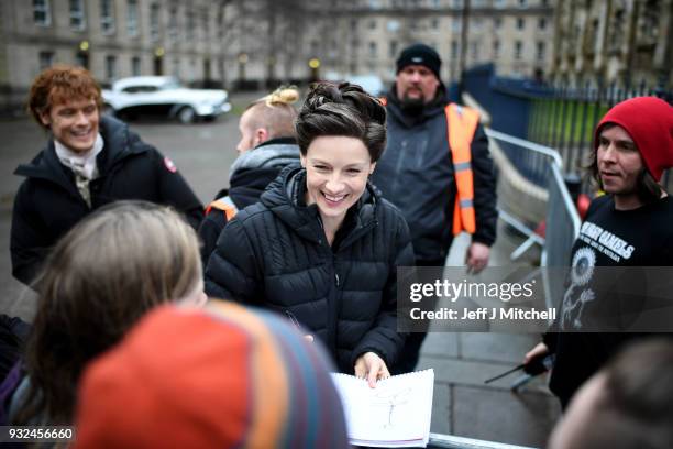 Catriona Balfe and Sam Heughan from the TV series Outlander departs a filming location at St Andrew's Square on March 15, 2018 in Glasgow, Scotland....