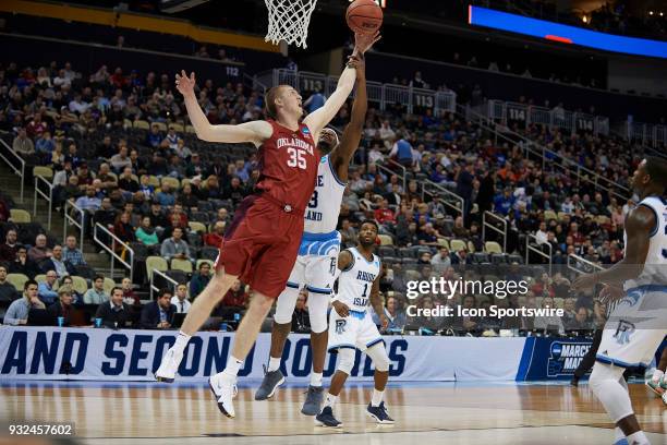 Oklahoma Sooners forward Brady Manek fights for the ball against Rhode Island Rams guard Stanford Robinson during the first half of the first round...