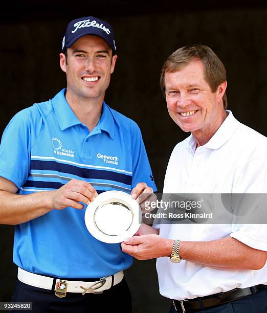 Ross Fisher of England is presented with the October Race to Dubai Golfer of the Month award by George O'Grady, Chief Executive of The European Tour...