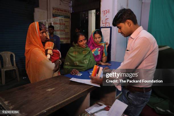 Pharmacist dispenses medicine at a pharmacy attached to DIMPA, a private OB-GYN clinic. The Abt Associates-led Private Sector Partnerships-One...