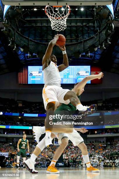 Admiral Schofield of the Tennessee Volunteers grabs a rebound over Loudon Love of the Wright State Raiders in the first half in the first round of...