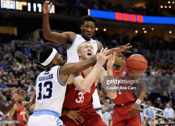 Brady Manek of the Oklahoma Sooners loses the ball on a block by Stanford Robinson of the Rhode Island Rams in the second half of the game during the...