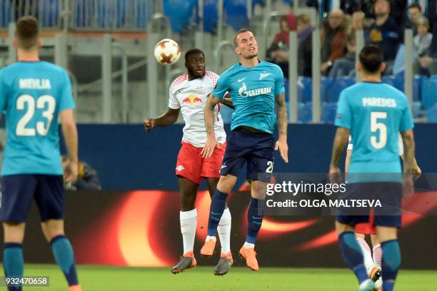 Leipzig's French defender Dayot Upamecano and Zenit St. Petersburg's Anton Zabolotny vie for the ball during the UEFA Europa League Round of 16...