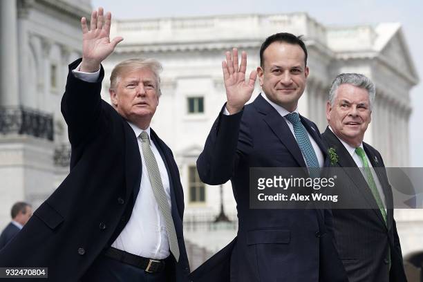 President Donald Trump and Irish Taoiseach Leo Varadkar wave as U.S. Rep. Peter King looks on after the Friends of Ireland luncheon March 15, 2018 on...