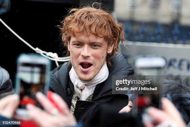 Sam Heughan from the TV series Outlander departs a filming location at St Andrew's Square on March 15, 2018 in Glasgow, Scotland. Dozens of fans have...