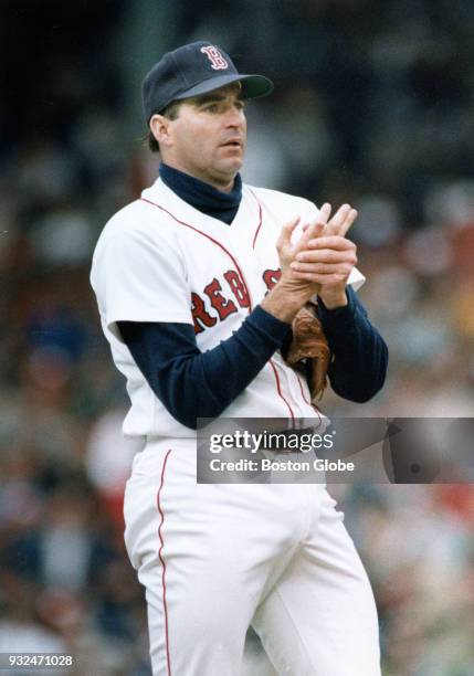 Boston Red Sox pitcher Bruce Hurst massages his hands during an ALCS game against the Oakland Athletics at Fenway Park in Boston, Oct. 5, 1988.