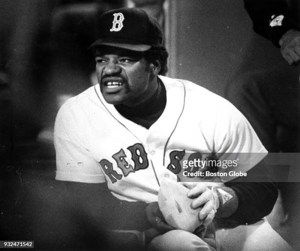 Boston Red Sox Dave Henderson warms his hands with a hot water bottle during the seventh game of the ALCS against the California Angels at Fenway...