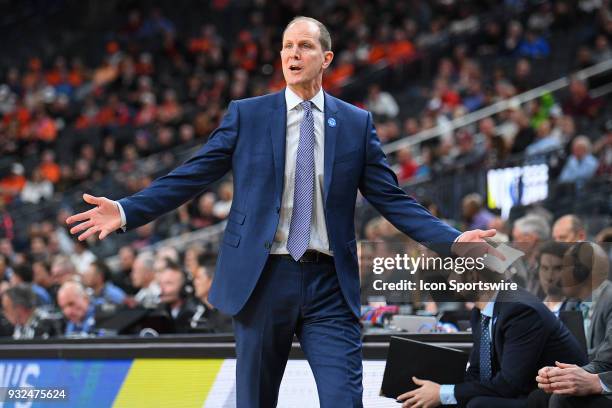 Washington head coach Mike Hopkins gives instructions during the first round game of the mens Pac-12 Tournament between the Washington Huskies and...