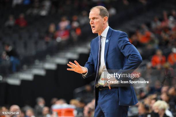 Washington head coach Mike Hopkins gives instructions during the first round game of the mens Pac-12 Tournament between the Washington Huskies and...