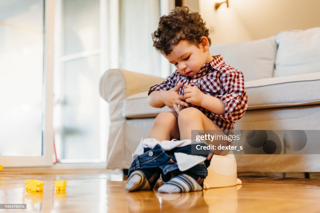 Little boy sitting on potty