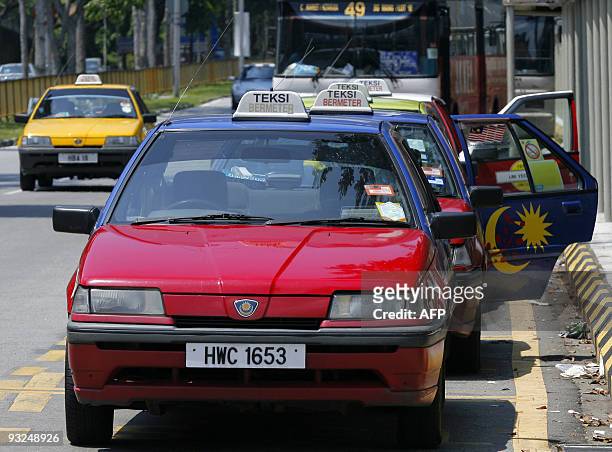 Malaysia-auto-company-Proton by M. Jegathesan A long queue of Malaysian-made taxis by national auto make Proton wait for customers in Kuala Lumpur on...