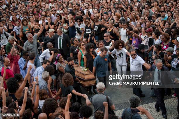 Politicians, friends and relatives carry the coffin of slain Brazilian councilwoman and activist Marielle Franco, during her funeral at Rio de...