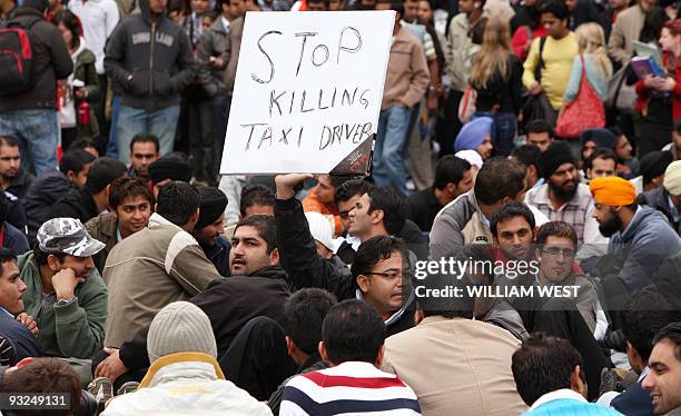 Taxi driver holds a banner aloft at a blockade involving taxi drivers in Melbourne's CBD before drivers received the safety concessions they were...