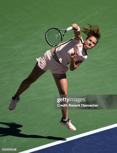 Daria Kasatkina of Russia serves against Angelique Kerber of Germany during Day 9 of BNP Paribas Open on March 15, 2018 in Indian Wells, California.