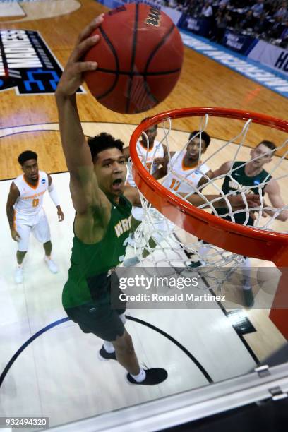 Mark Hughes of the Wright State Raiders dunks the ball against the Tennessee Volunteers in the first round of the 2018 NCAA Men's Basketball...