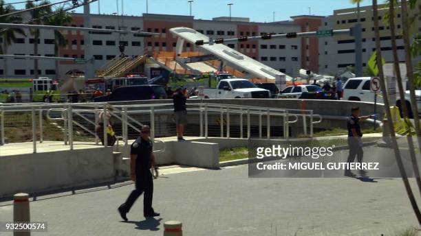 This AFP TV video frame grab shows a newly installed pedestrian bridge over a six-lane highway in Miami on a college campus that collapsed on March...