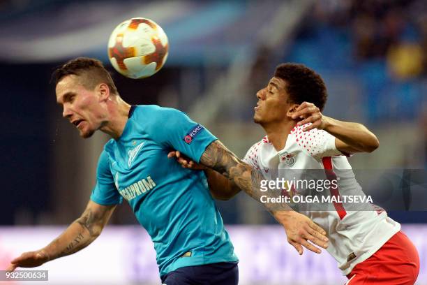 Zenit St. Petersburg's Anton Zabolotny and Leipzig's Brazilian defender Bernardo vie for the ball during the UEFA Europa League Round of 16 second...