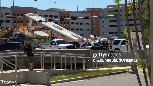 This AFP TV video frame grab shows a newly installed pedestrian bridge over a six-lane highway in Miami on a college campus that collapsed on March...