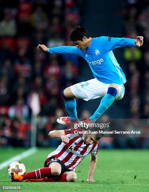 Inigo Lekue of Athletic Bilbao duels for the ball with Hiroki Sakai of Marseille during UEFA Europa League Round of 16 match between Athletic Club...
