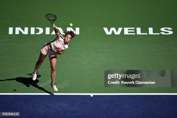 Daria Kasatkina of Russia serves against Angelique Kerber of Germany during Day 9 of BNP Paribas Open on March 15, 2018 in Indian Wells, California.