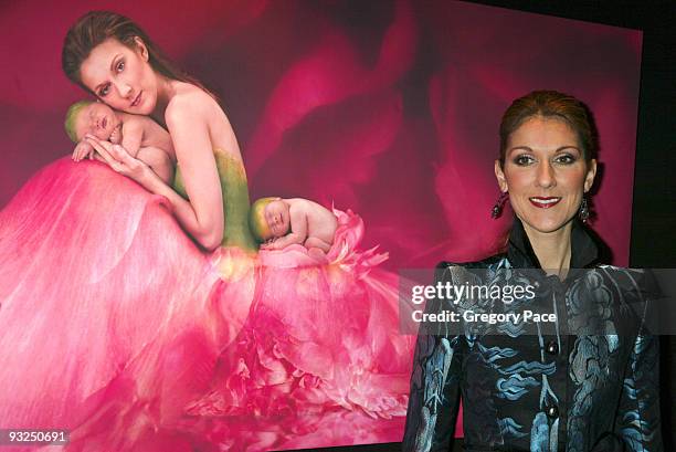 Celine Dion poses in front of the Anne Geddes photo of her