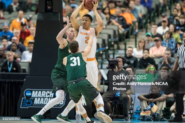 Tennessee Volunteers forward Grant Williams tries to pass the basketball over Wright State Raiders center Parker Ernsthausen and guard Cole Gentry...