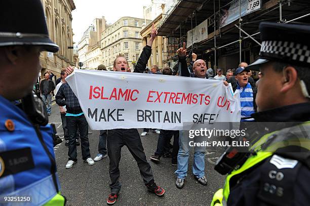 Protestors from the English Defence League hold a banner with the words ' Islamic Extremists Out, Make Britain Safe' during a demonstration in...