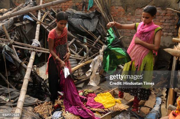 Day before their wedding, two sisters Jyotsna and Kalpana Khatoon show burnt new sari in a major fire that broke out at a godown on Armenian Ghat off...
