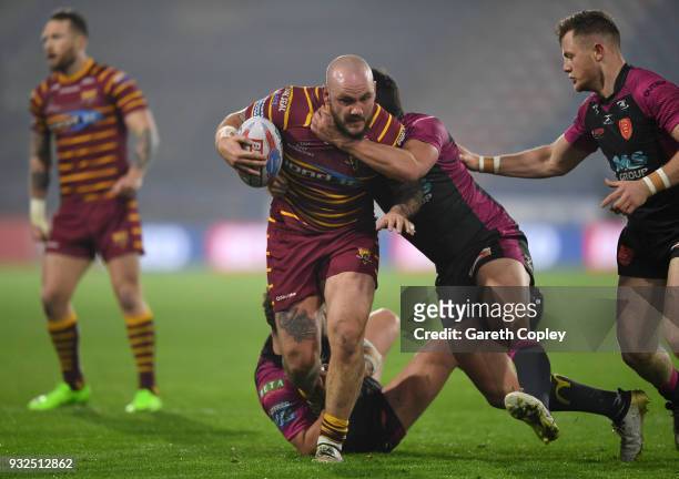 Dale Ferguson of Huddersfield Giants is tackled by Danny McGuire of Hull KR during the Betfred Super League match between Huddersfield Giants and...