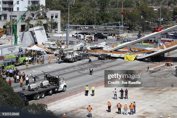 Miami-Dade Fire Rescue Department personel and other rescue units work at the scene where a pedestrian bridge collapsed a few days after it was built...