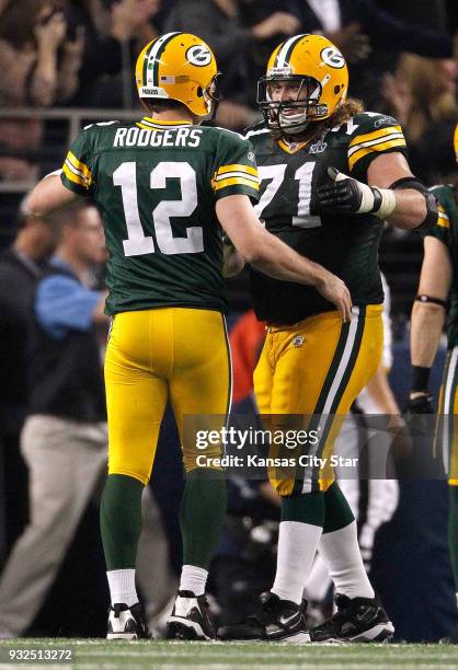 Green Bay Packers quarterback Aaron Rodgers celebrates after a play with Green Bay Packers guard Josh Sitton in third quarter action in Super Bowl...