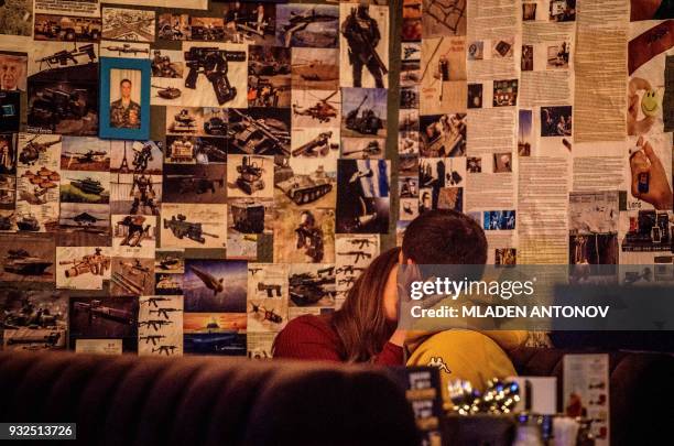 Patrons enjoy the privacy of the "Intelligence" spy themed bar near the famous KGB and current FSB building on Lubyanka square in Moscow on March 15,...
