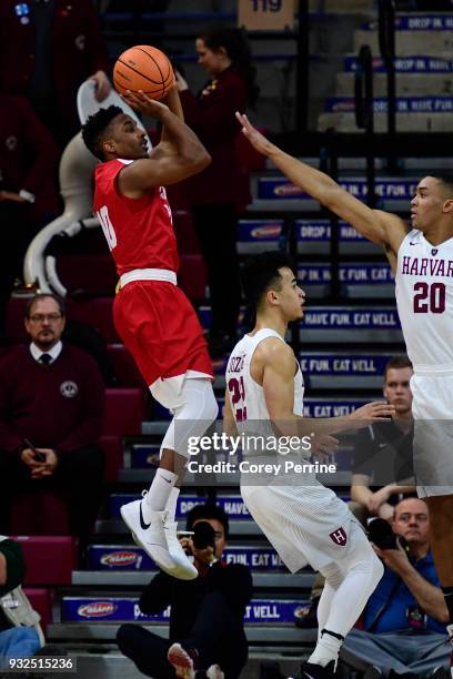 Matt Morgan of the Cornell Big Red shoots the ball against Justin Bassey of the Harvard Crimson during the first half of a semifinal round matchup in...