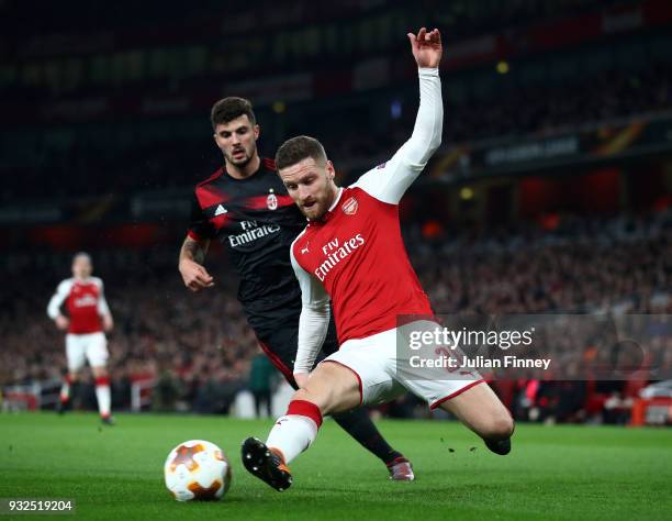 Shkodran Mustafi of Arsenal clears the ball from Patrick Cutrone of AC Milan during the UEFA Europa League Round of 16 Second Leg match between...