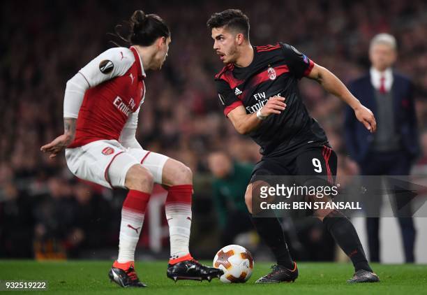 Arsenal's Spanish defender Hector Bellerin vies with AC Milan's Portuguese striker André Silva during the UEFA Europa League round of 16 second-leg...