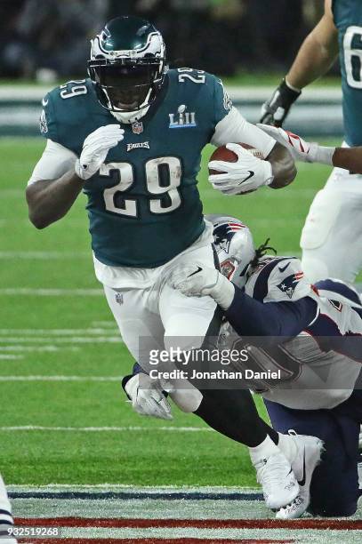 LeGarrette Blount of the Philadelphia Eagles is grabbed by Malcom Brown of the New England Patriots during Super Bowl Lll at U.S. Bank Stadium on...