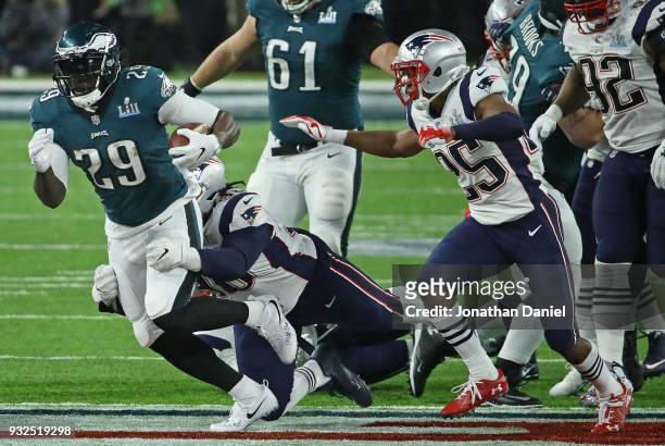 LeGarrette Blount of the Philadelphia Eagles is grabbed by Malcom Brown of the New England Patriots during Super Bowl Lll at U.S. Bank Stadium on...