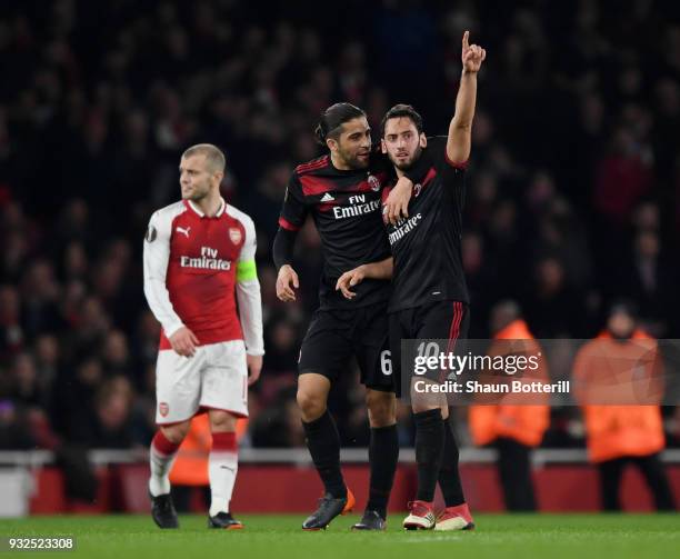 Hakan Calhanoglu of AC Milan clebrates the opening goal with Ricardo Rodriguez as Jack Wilshere of Arsenal looks on during the UEFA Europa League...