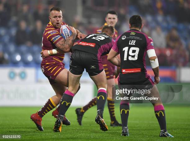 Tyler Dickinson of Huddersfield is tackled by James Greenwood of Hull KR during the Betfred Super League match between Huddersfield Giants and Hull...