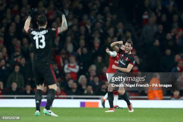 Milan's Hakan Calhanoglu celebrates scoring his side's first goal of the game during the UEFA Europa League round of 16, second leg match at the...