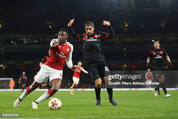Ricardo Rodriguez of AC Milan fouls Danny Welbeck of Arsenal resulting in a penalty during the UEFA Europa League Round of 16 2nd leg match between...