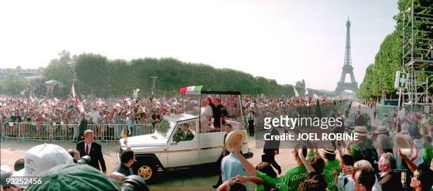 Pope John Paul II arrives at the Champ de Mars on board his "popemobile" amid an estimated crowd of 500,000 worshippers who are welcoming the...