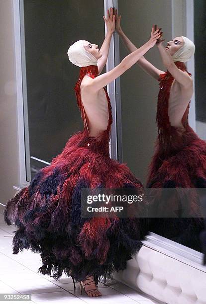 British model Erin O'Connor presents a creation by Alexander Mcqueen for the Spring/Summer collection at London fashion week in London 26 September...